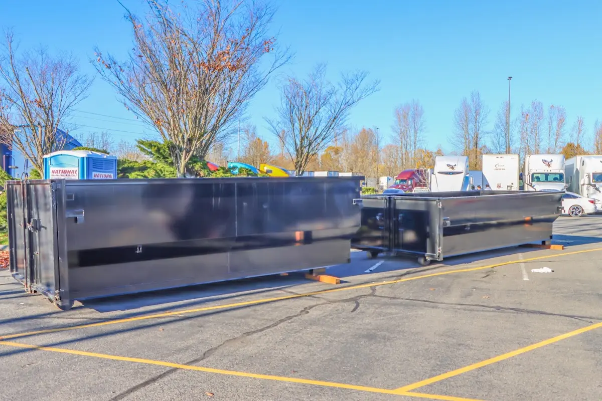 Professional dumpster rental service with roll-off container on residential driveway in Fircrest